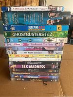Photo of all DVDs, one Blu-ray and VHS movies stacked, showing titles and cases in good condition.