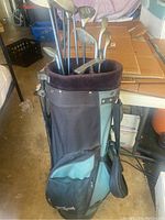 Photo of golf bag containing multiple left handed golf clubs with varied heads and shafts