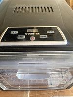 Top view showing the digital control panel with timer, temperature, and power buttons, LED display with Gourmia branding.