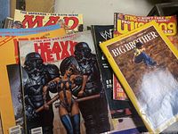 Pile of mixed magazines showing covers of Heavy Metal, Big Brother skateboarding, and others