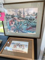 Overview of two framed artworks, a signed watercolor on top and a matted print below