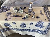 Full view of the tablecloth spread on a table with all ceramic items displayed
