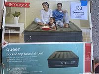 Box front showing Embark branding with image of air bed inflated indoors with people sitting on it.
