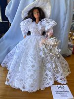 Two photos showing the vintage Heritage Mint Collection Wedding Barbie wearing a white lace wedding dress with puffed sleeves and lace hat, holding bouquet of flowers. Additional doll included in lot but not fully shown.