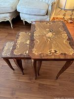 Set of three nesting tables arranged together showing intricate wood inlay tops and matching leg designs