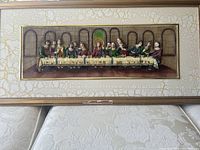 Full view of the framed resin relief sculpture of The Last Supper, showing all figures sitting at the table and architectural background.
