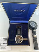 Seiko dive watch and Rawlings pocket watch in Seiko presentation box