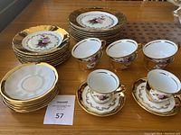 Overhead view of all plates, cups and saucers on wood table