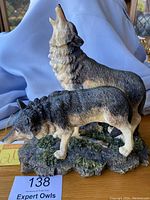 Front and angled views of the two wolf resin figurine showing detailed sculpting and textured base