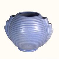 Front and slightly angled view showing ribbed texture, rounded form and cornflower blue finish of the vase.