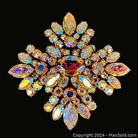Front view displaying the full decoratively shaped floral rhinestone brooch with aurora borealis stones.