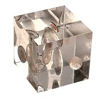 Clear lucite cube paperweight with visible embedded Canadian coins from 1966 inside, showing multiple external and internal reflections of the coins.
