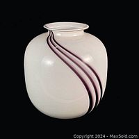 Front view of white glass vase with three purple racing stripes curving around body, showing rounded shape and short flared neck.