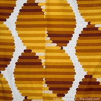 Close-up detail of fabric pattern showing yellow, amber, and brown beehive shapes with horizontal stripes.