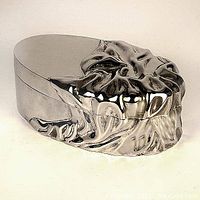 Closed view of silver-plated oval dresser box showing sculpted textured design on sides and lid edges with smooth top.