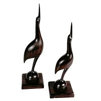Front view of two carved ironwood birds on square bases showing elegant smooth lines and polished dark wood finish.