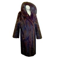 Front view of the vintage mink coat on mannequin showing collar, three-quarter sleeves, and front closure