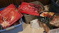 Boxes with holiday motifs, including a display box with a red holiday decoration scene that likely belongs to the Winter Wonderland Lazy Susan and other decorative items.