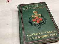 Front cover of the green hardcover book showing the title 'The Story of the Dominion A History of Canada for Four Hundred Years' with an ornate crest.