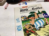 Front cover of 'Asterix and the Goths' comic book showing colorful illustration by Goscinny and Uderzo, highlighting key characters and title.