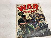 Front cover of War Combat comic issue 8 illustrating a wartime battle scene between soldiers, showing wear and creases.