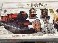 Front box image showing the complete set featuring Hogwarts Express steam train and three Diagon Alley buildings as 3D puzzles, with 453 pieces total.