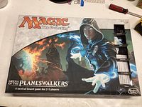 Box cover of Magic: The Gathering Arena of the Planeswalkers showing main artwork and game title
