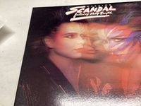 Front cover of 'Warrior' vinyl LP by Scandal featuring Patty Smyth showing stylized portrait with multiple exposures