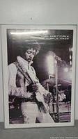 Frontal view of the framed Jimi Hendrix Purple Haze poster featuring Jimi playing guitar on stage with microphone stand.