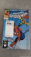 Cover photo of The Amazing Spider-Man comic with Spider-Man and Nova characters, light crease visible