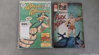 Front covers of Wonder Woman and Doom Patrol comics showing character art and issue details.