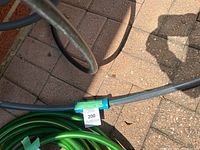 Close up of blue garden hose connector showing hose condition and material.