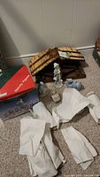 Photo of the nativity scene stable, some wrapped figurines and box