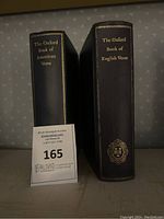 Two hardcover books placed side by side showing titles on spines: The Oxford Book of American Verse and The Oxford Book of English Verse.