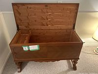 Open chest from side showing interior cedar lining and carved legs