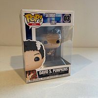 Front and side view of new Funko Pop! David S. Pumpkins figure in original packaging, showing branding, model number and figure detail.