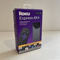 Front side of sealed retail box for Roku Express 4K+ streaming device showing product image and key features including 4K HDR and voice remote.