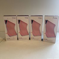 Front view of four boxed Tilted Nation Oversize RGB Gaming Mousepads in pink color.