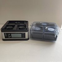 Viante Intellisteam food steamer base on left with three individual steaming compartments stacked to the right, showing separated sections and digital control panel on base