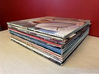 Stack of 25 vintage LP record albums showing a thick pile of assorted titles and album covers.