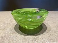 Green glass bowl by Anna Ehrner Kosta Boda showing swirl pattern and shape