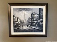 Framed black and white painting of a Paris street scene featuring the Eiffel Tower and pedestrians, hanging on a wall.