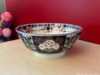 Side angle view of the vintage Japanese Imari bowl showing detailed gold and multi-colored hand-painted floral and geometric patterns.