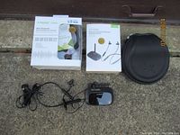 Full lot showing boxed Avantree NFC Bluetooth stereo headphones, boxed wireless in-ear headphones transmitter set, wired earbud headphones, and black carrying case.