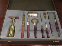 Full set nicely seated in fitted foam tray inside a case, showing all 8 items with rosewood handles and silver plated metal parts.