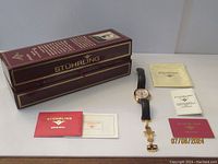Watch with original presentation box and documentation laid out