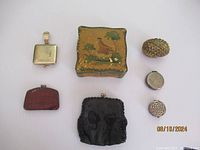 Overview of the lot showing all items including purses, trinket boxes, ashtray, and small decorative items.