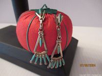 Front view of triangular Zuni earrings with needlepoint petot point turquoise inlays.