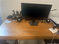 Top-down view of the study table with computer monitor, speakers, and various small desk items placed on top.