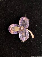 Front view showing three oval faceted amethysts in clover arrangement with central rosette